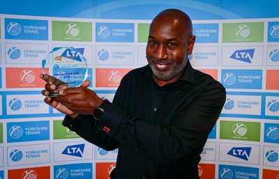 Man holding tennis award