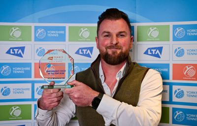 Man holding tennis award
