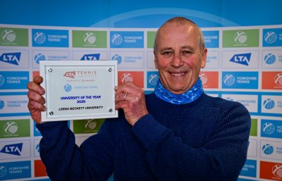 Man holding tennis award